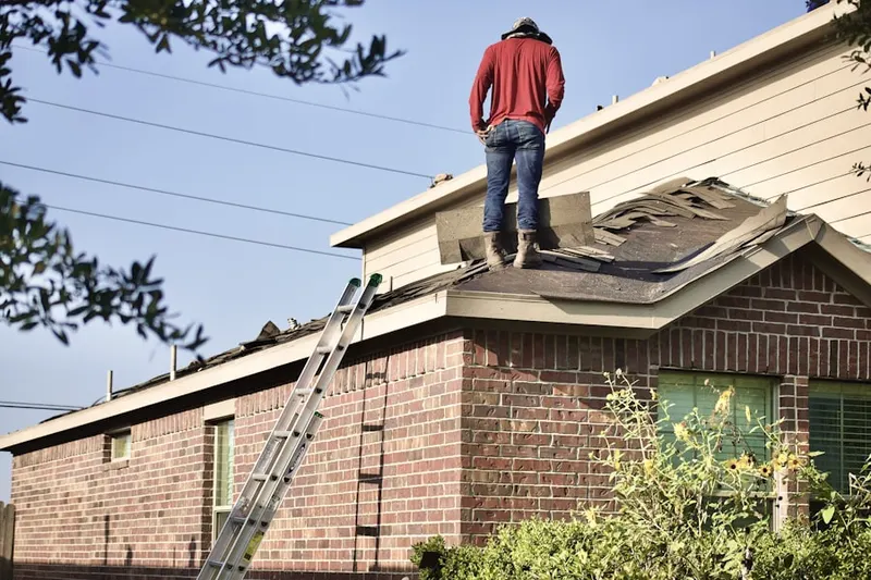 Professional roofer working on a residential roof in Granger